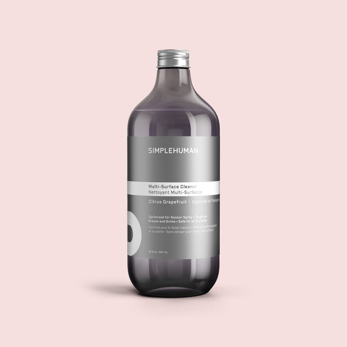 Simplehuman's Citrus Grapefruit Multi-Surface Cleaner Refill Bottle on a colored background.