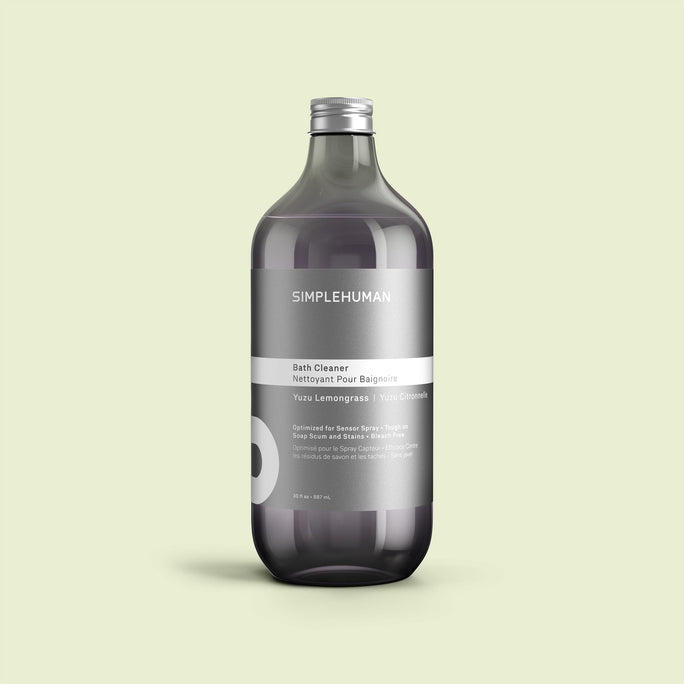 Simplehuman's Yuzu Lemongrass Bath Cleaner Refill Bottle on a colored background.