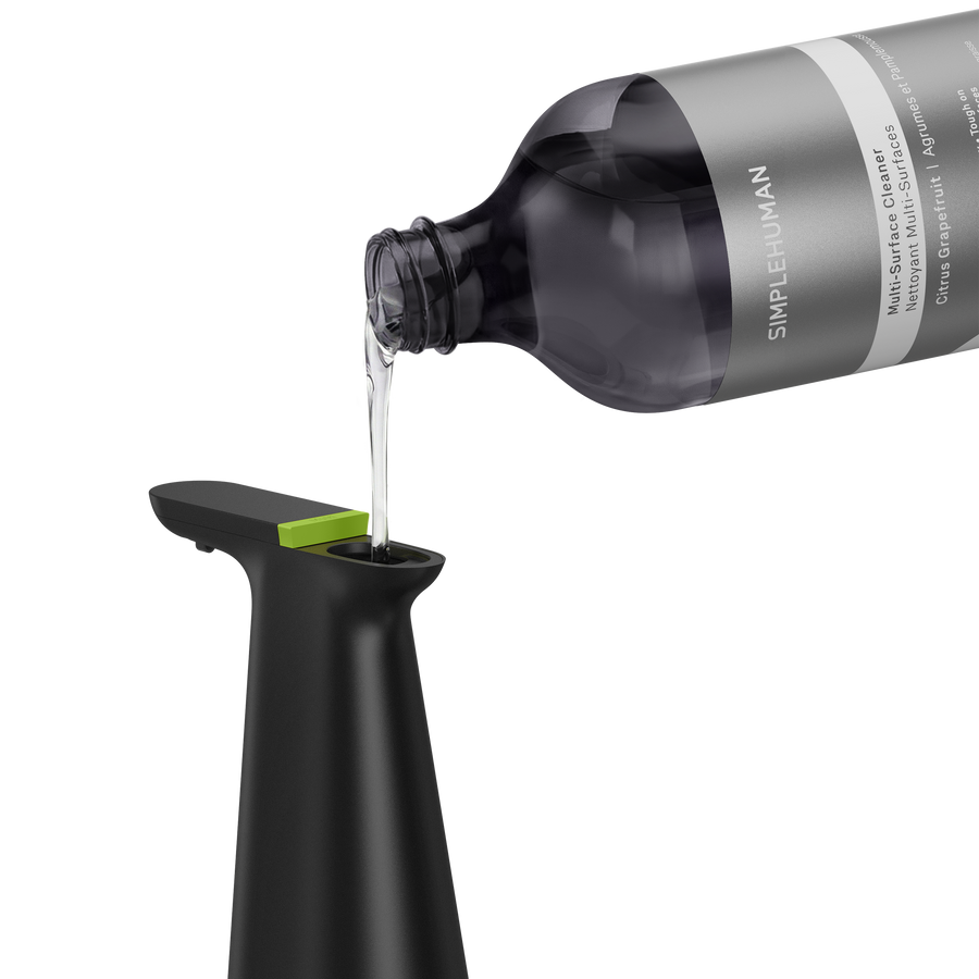 Simplehuman's Sensor Spray in Matte Black with the Multi-Surface Cleaner Refill Bottle pouring into the spout
